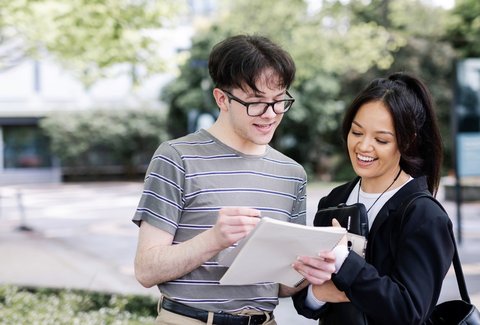 Two students having a conversation on campus.