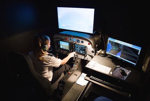 A woman operating a flight simulator