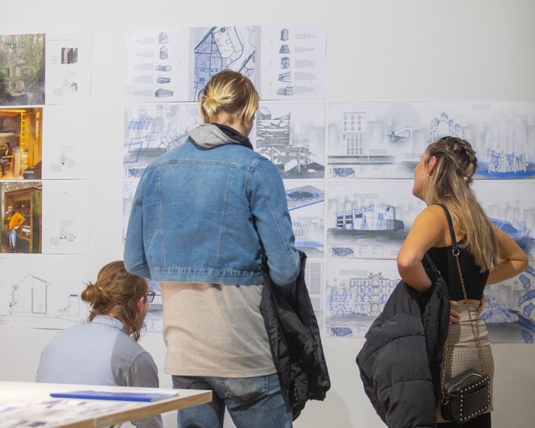 Students looking at spatial design concepts at exposure event at Massey University.