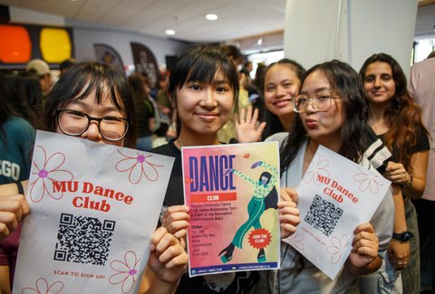 Clubs day at Orientation in Palmerston North. Three students holding flyers about clubs on campus.
