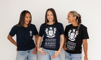 Group of staff and students showcase their Massey Merchandise tshirts